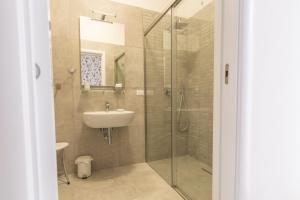 a bathroom with a glass shower and a sink at B&B Napoli Centro in Naples