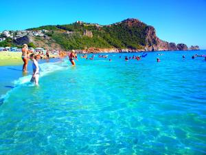 a group of people in the water at a beach at Ark Apart and Suite Hotel in Alanya