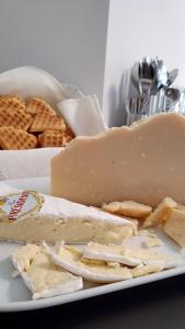 a white plate with cheese and waffles and waffleergy at B&B I LAKE IT BELLAGIO in Bellagio