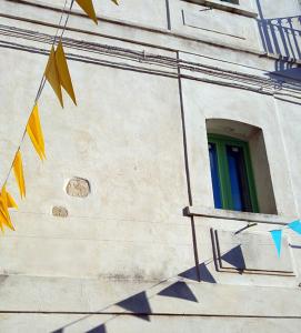 a building with a window with a rainbow at BORGO PETELIA, Casa Castiglione, Antica casa su due piani con scala esterna in Strongoli