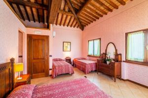 a large room with two beds and a mirror at Agriturismo Settepassi Tuscany in Ponte Buggianese