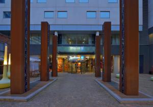 a building with a row of wooden poles in front at Radisson Blu Hotel, Liverpool in Liverpool