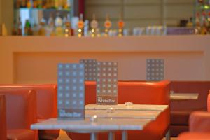 a table in a restaurant with orange chairs at Radisson Blu Hotel, Liverpool in Liverpool