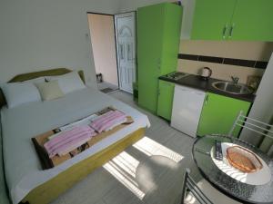 a bedroom with a bed and a table and a kitchen at Apartments Blago Sutomore in Sutomore