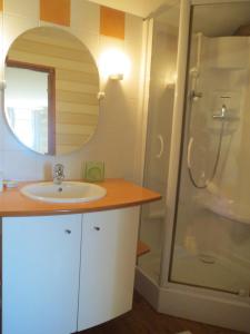 a bathroom with a sink and a shower at La Haute Gilberdière in Sartilly +75 photos