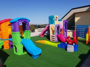 a playground with different types of play equipment at Hotel Grado in Bellaria-Igea Marina