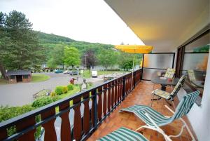 a balcony with two chairs and a view of a street at Haus Panorama in Simmerath