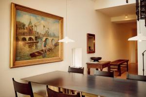 a dining room table with a painting on the wall at Hotel Miss Blanche in Groningen