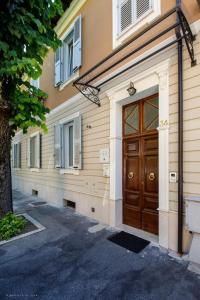 a building with a wooden door next to a street at C'era Un Lago in Avezzano