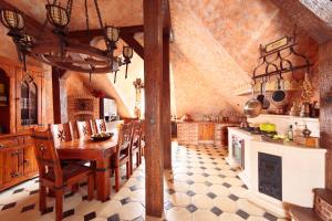 a large kitchen with a wooden table and chairs at Attic Apartment Warszawa in Warsaw