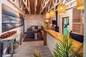 a living room with a couch and a table at The Bungalow in Plettenberg Bay