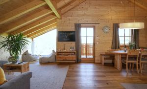 a living room with a table in a wooden house at Chalet Oberguggenberg in San Lorenzo di Sebato