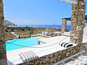 a villa with a pool and a view of the ocean at Cavo Blue Villas in Elia Beach