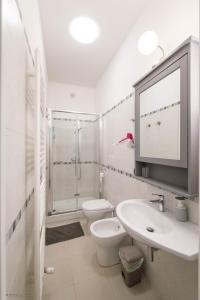 a white bathroom with a toilet and a sink at C'era Un Lago in Avezzano