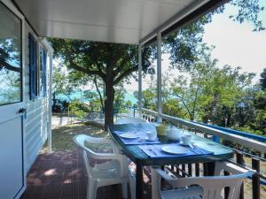 a blue table and chairs on a porch at Camping Genova Est in Bogliasco