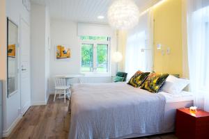 a bedroom with a bed and a dining room at Hotel Amandis in Naantali