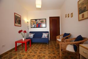 a living room with a blue couch and a table at CASA RENATA in Castellabate