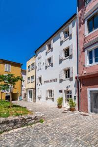 a white building with the words first market on it at Idassa Palace rooms in Zadar