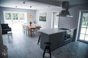 a kitchen and dining room with a table and a counter at Przystań Piecek in Stręgielek