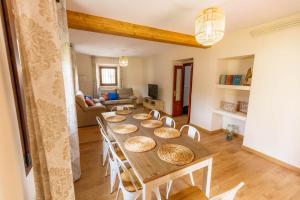 a dining room with a table and a living room at La capitana Llanes in Llanes