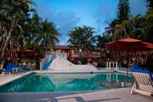 a swimming pool with a slide in a resort at Los Andes Coatzacoalcos in Coatzacoalcos