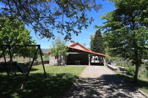 a park with a building with a swing at Casa do Rolo by Trip2Portugal in Montalegre