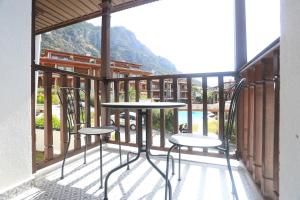 a balcony with two chairs and a table on a balcony at Verde Suites Akyaka in Akyaka