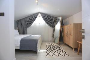 a bedroom with a bed and a large window at Verde Suites Akyaka in Akyaka +91 photos