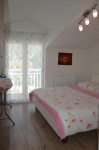 a white bedroom with a bed and a window at Apartments Babic in Podstrana +102 photos