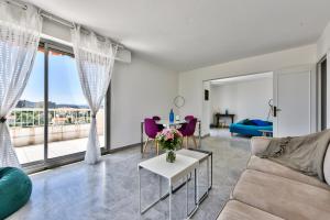 a living room with a couch and a table at Amazing seaview Two-bedroom in Antibes