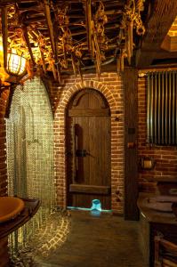 a room with a wooden door and a brick wall at Attic Apartment Warszawa in Warsaw