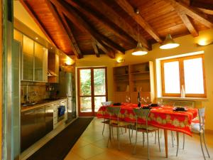 a kitchen with a table with a red table cloth at Villa Russo in Castel di Sangro