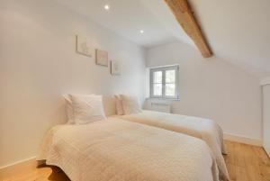 a bedroom with two beds and a window at Meuble prestige in Nancy