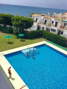 an overhead view of a swimming pool with people in it at Level 11 Apartment in Aguadulce