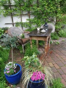 un patio con mesa, sillas y plantas en Möbliertes Zimmer, Plüderhausen en Plüderhausen