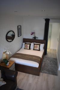 a bedroom with a large bed with pillows on it at Boatyard View in Sandwich