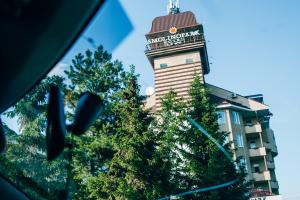 un edificio con una torre de reloj en el fondo en SmolinoPark Hotel, en Chelyabinsk