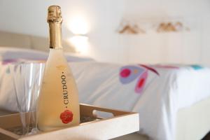 a bottle of champagne in a box next to a glass at notti vesuviane in Portici