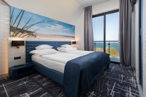 Posteľ alebo postele v izbe v ubytovaní Hotel Faleza - z widokiem na morze