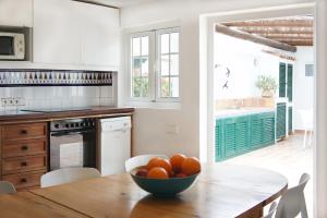 a kitchen with a table with a bowl of oranges on it at Casa Jable Azul in Adeje