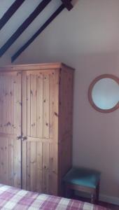 a bedroom with a bed and a dresser at The Lincolnshire Poacher Inn in Metheringham