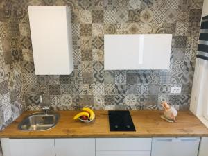 a kitchen with a sink and a counter with a banana at Paradise Stone Apartments in Bol