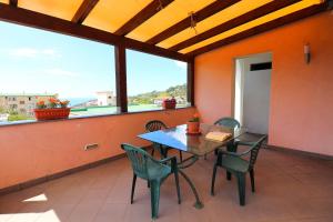 a patio with a table and chairs and a view of the ocean at Casa Vacanze Il Postino in SantʼAgata sui Due Golfi