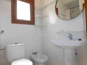 a bathroom with a toilet and a sink and a mirror at Rentalmar El Capitan in Hospitalet de l'Infant