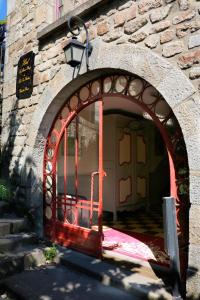 an entrance to a building with a red door at La Mère Poulard in Le Mont Saint Michel