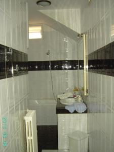 a white bathroom with a sink and a tub at Villa Nicolaus in Bari