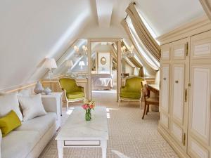 a living room with a couch and a table at Le Meurice – Dorchester Collection in Paris
