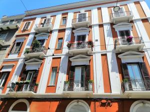 an orange and white building with windows and balconies at BARI 102 in Bari
