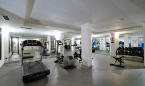 a gym with treadmills and machines in a building at MS Aguamarina Suites in Torremolinos