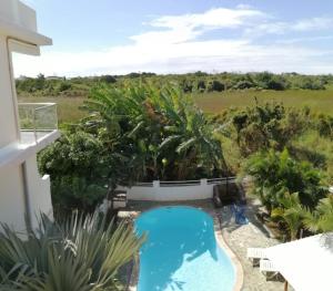 a view of a pool from the balcony of a house at Dahlia Villa valari in Pereybere